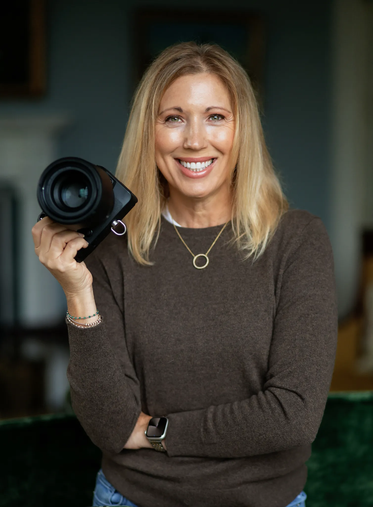 Julie Massie smiling and holding her camera
